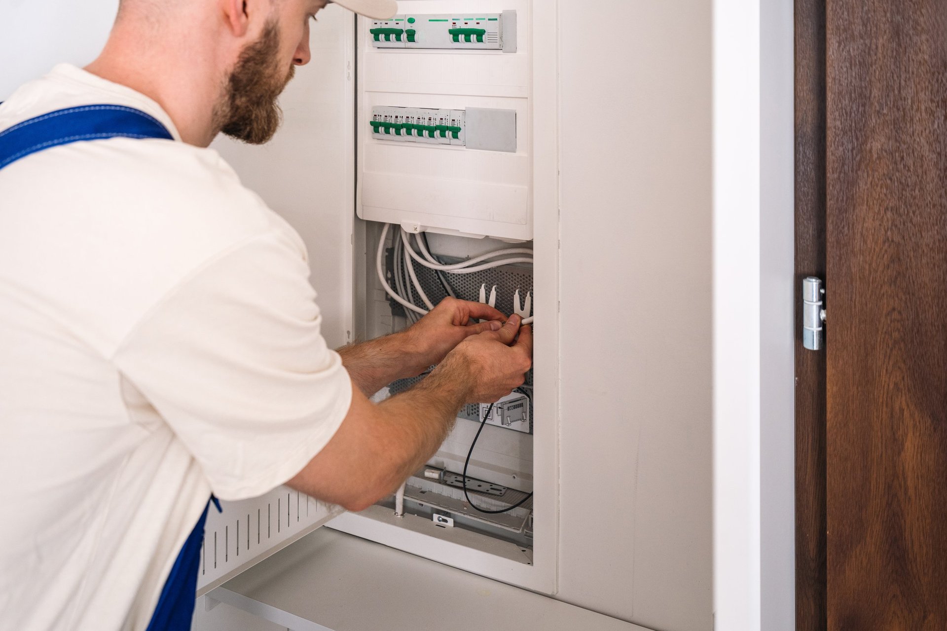 Electrician working on electrical panel